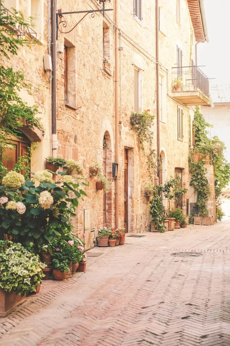 Tuscany, Italy I Flower-filled alleyway in the golden village of Pienza acrylic glass by Julie Travel Photography
