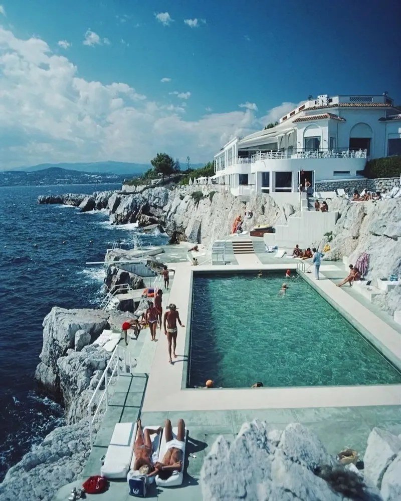 Sunbathing at the Beachside Pool Antibes, 1976 - Slim Aarons canvas by The Poster UK