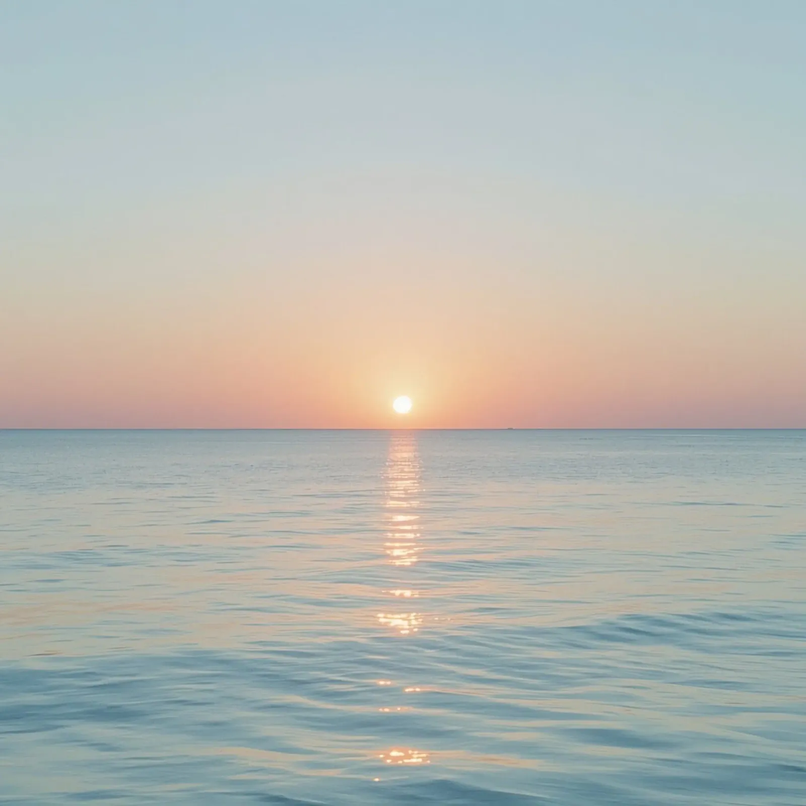 Sunset over calm ocean waters with pastel hues reflecting hahnemühle by DesignDoodle