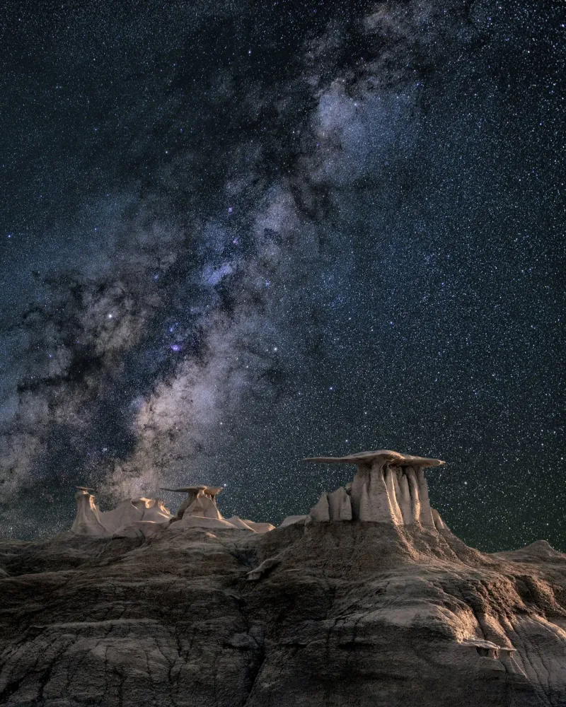 rock formations behind starry sky canvas by space words