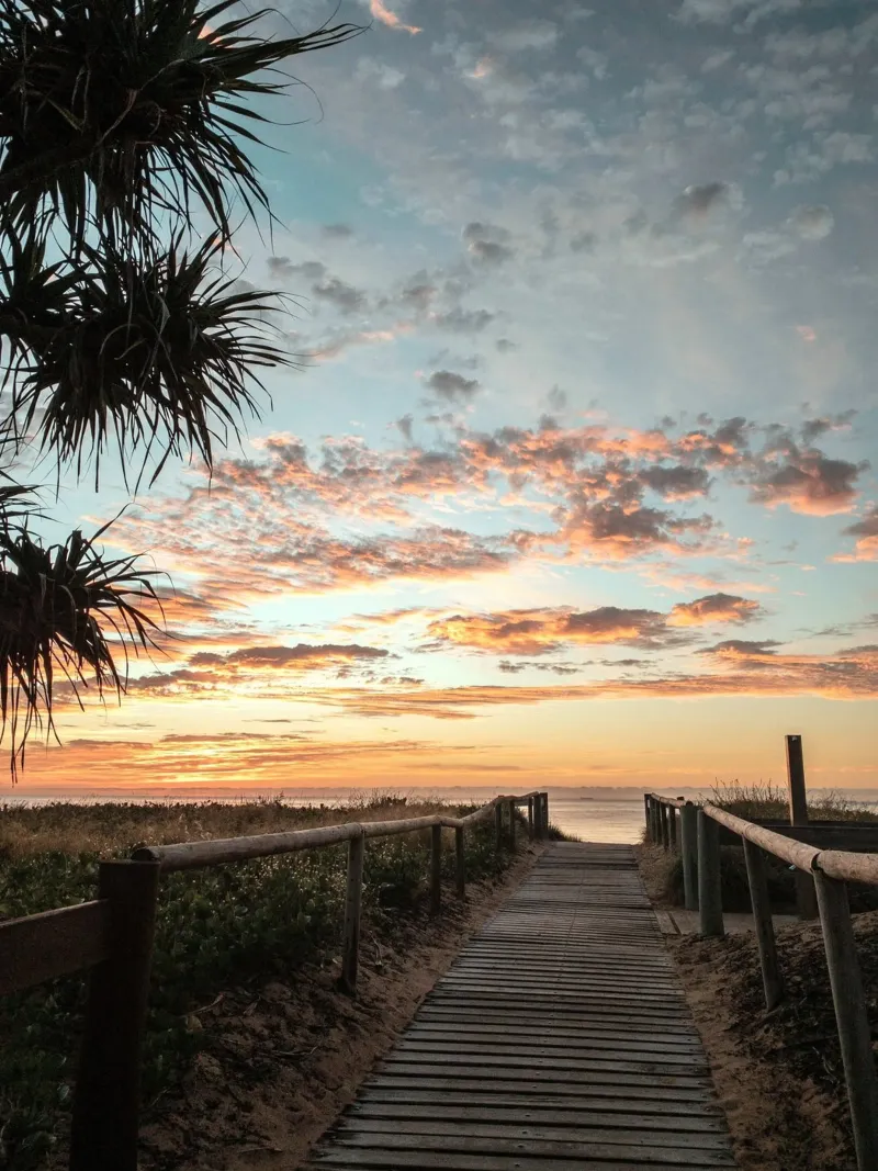 wooden pathway to the sunset beach backlit film by life of sands