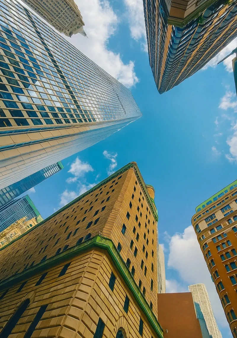 view of the sky from under a tall building hahnemühle by PASMING