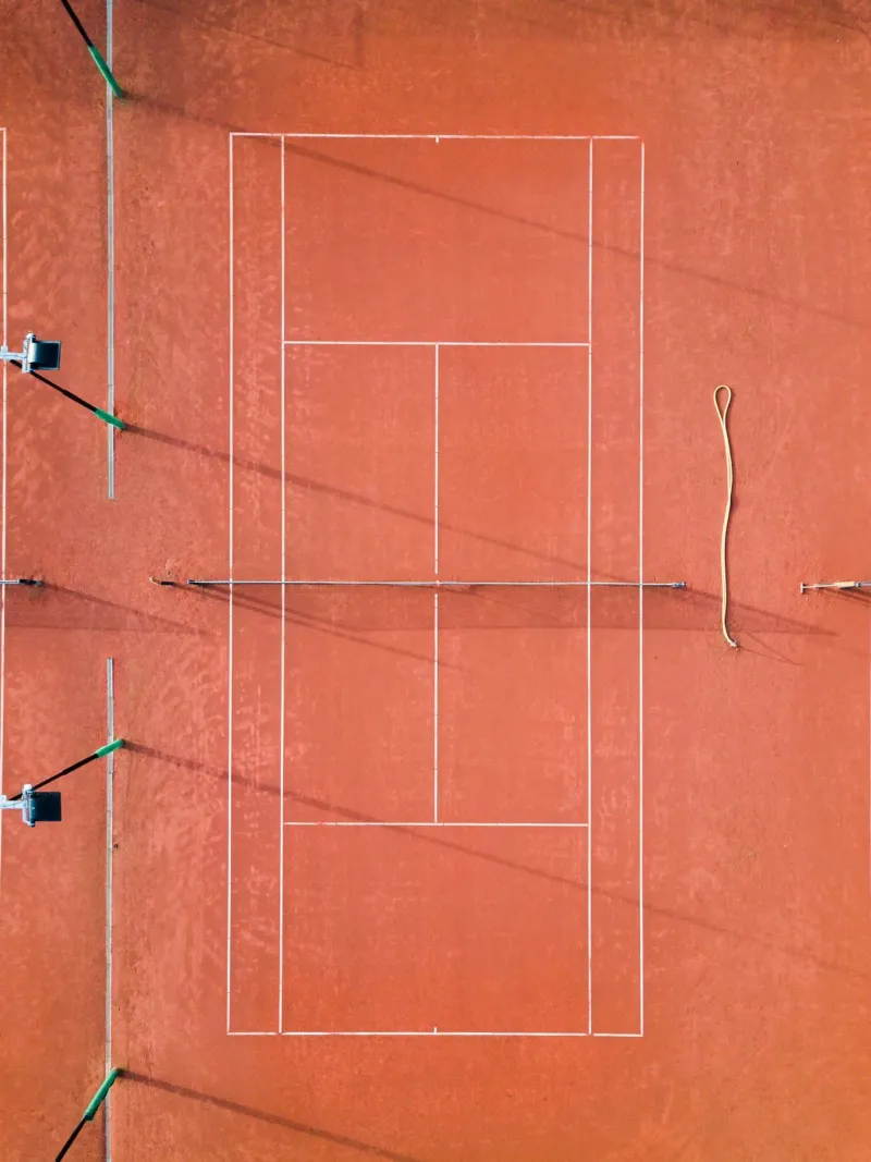 Red Tennis Court at Sunrise - Colorful Photography poster by Raisa Zwart Photography